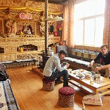 Tibetan House Visit  Visiting a typical tibetan house - here having lunch in front of the stunning house alltar.